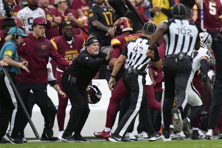 Washington Commanders coach bloodied after collision with quarterback