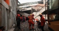 Rescuers run oxygen to survivors in Indonesia school building collapse that buried dozens