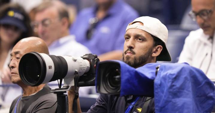 Basketball player Landry Shamet takes his shots as a photographer working at the US Open
