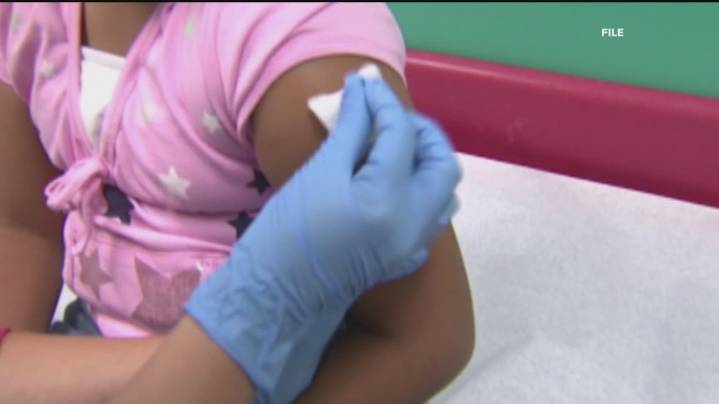Vaccine skeptics draw cheers, howls outside CDC