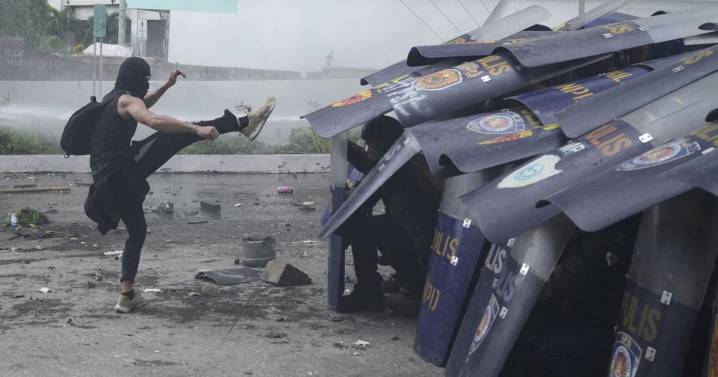 Philippine police arrested dozens after a violent clash near presidential palace, in photos
