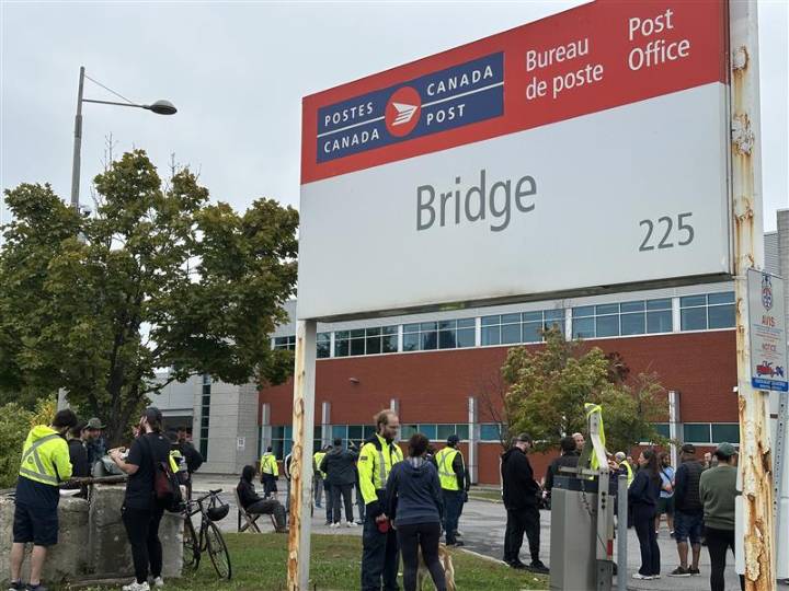 Canada Post workers picket in Montreal, as they walk off the job across the country