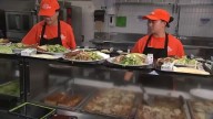 Staff and volunteers serve meals to seniors in West Harlem, NYC on National Food Bank Day