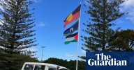 Traditional owners, police and Queensland government in stoush over unauthorised flagpoles on Stradbroke Island