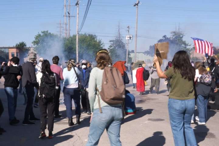 Federal agents fire chemicals as protesters try to block car at immigration site outside Chicago