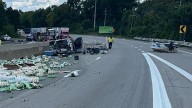 Bottles, boat left on road in multi