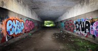 Dark, muddy and covered in graffiti - something is finally being done about M60 underpass that links two communities