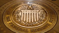 Federal Reserve cuts key rate by quarter-point and signals two more cuts this year