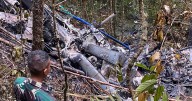 Mystery as rescuers find helicopter wreckage in jungle but recover only one of eight bodies