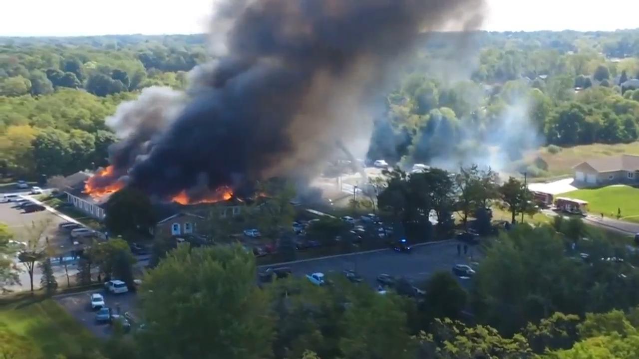 Fire engulfs Michigan church as police respond to shooting which killed 1, injured 9