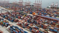 Shipping companies support a first-ever global fee on greenhouse gases, opposed by Trump officials