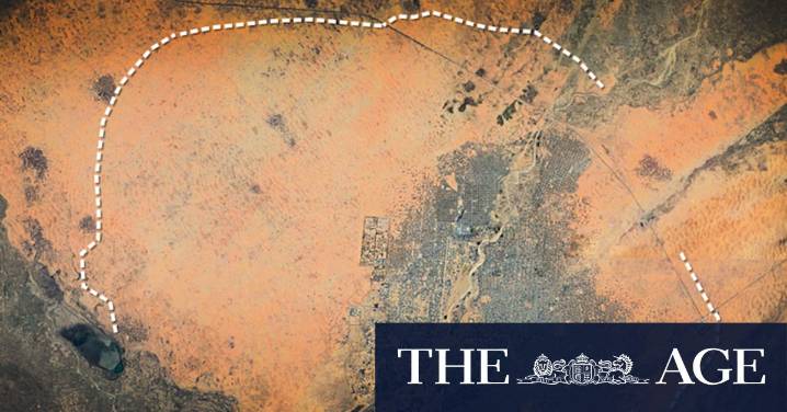 Soldiers build giant wall of dirt around city to trap 