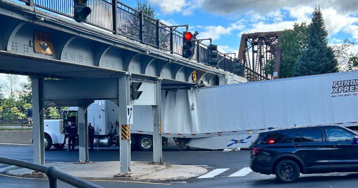 Another transport truck stuck under Fredericton overpass