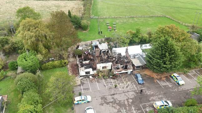 Crossbow wielding man dies after fiery police standoff at burning pub