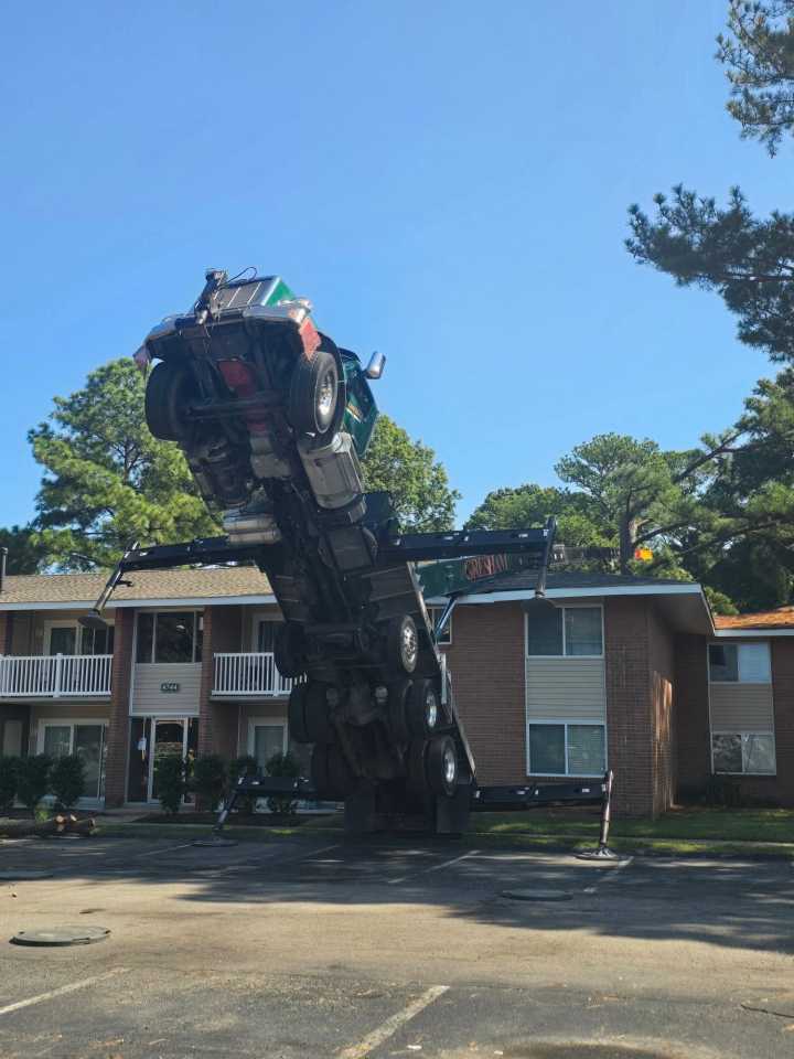 Crane tips onto Virginia apartment building
