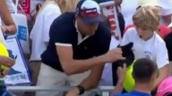 CEO apologizes for taking hat from boy at U.S. Open
