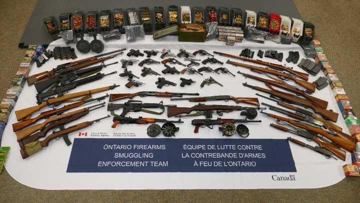 Man charged after officials seize 48 guns, thousands of bullets at U.S.