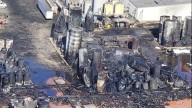Damaged tank bursts at Smitty's Supply during cleanup efforts