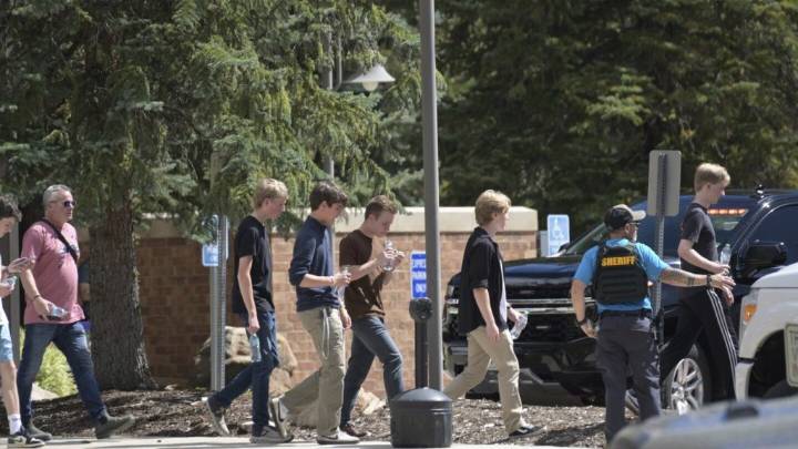 Authorities say student who had been radicalized fired revolver at Colorado school, wounding 2