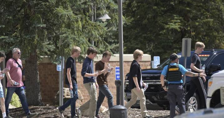 Authorities say student who had been radicalized fired revolver at Colorado school, wounding 2