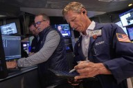Wall Street ticks toward another record as Tesla vrooms higher