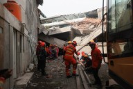 Rescuers run oxygen to survivors in Indonesia school building collapse that buried dozens
