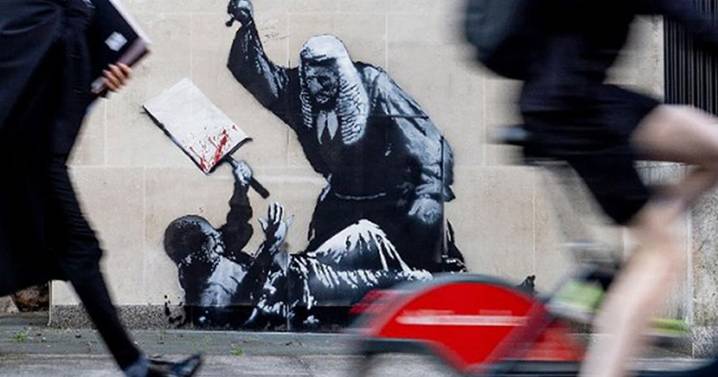 New Banksy artwork shows judge beating protester as Royal Courts of Justice cover it up