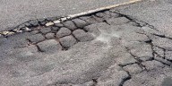 Potholes, cracks, blind spots on road near I-26 leave neighbors frustrated