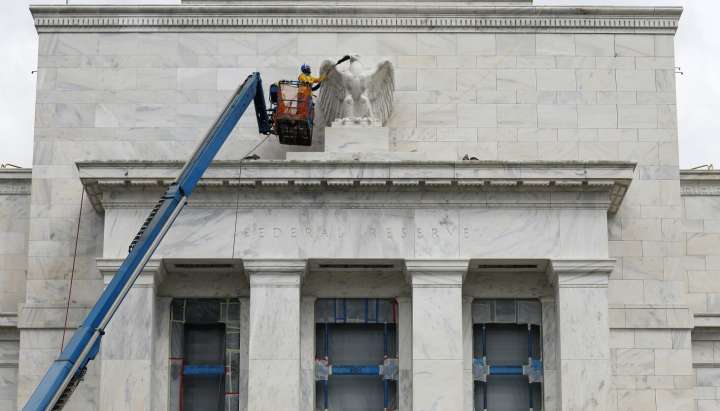 Federal Reserve cuts key rate by quarter-point, signals two more cuts this year