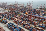 Shipping companies support a first-ever global fee on greenhouse gases, opposed by Trump officials