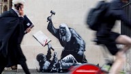 Banksy mural of judge beating protester is scrubbed from London court