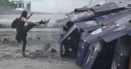 Philippine police arrested dozens after a violent clash near presidential palace, in photos