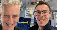 Glasgow actor Peter Capaldi pictured smiling with Scotrail staff on train
