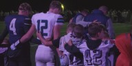 Crosstown rivals come together for moment of prayer after football game