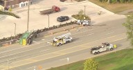Garbage truck driver dies after being hit by Jeep, sliding on its side in Orion Township,