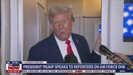 Trump speaks to reporters on Air Force One
