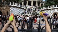 Activists squirt water guns at tourists at anti-tourism protest in Barcelona