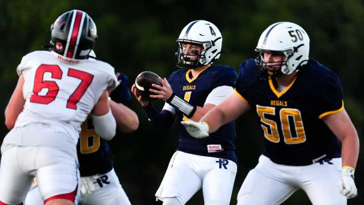 QB Kyle Tracy warms up before Regina's Week 2 game against West Branch