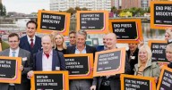 Hugh Grant joins campaigners with sign outside Labour Party conference