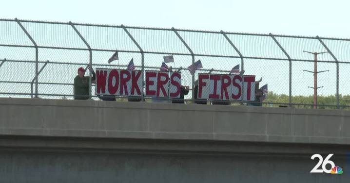 Locals display Labor Day message on highway overpass to promote worker unity