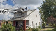 WATCH: 'Lucky' dog trapped on 'woof' of house rescued by Canton firefighters