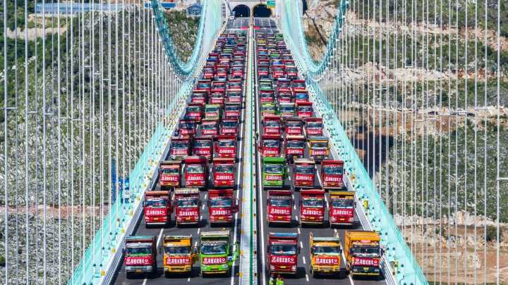 World's tallest bridge put to the ULTIMATE test as fleet of 96 trucks loaded with 3,360 tons of cargo park on crossing
