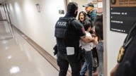Federal agent pushes woman to floor in immigration courthouse confrontation that sparks outrage