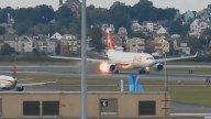 Flames shoot from plane, prompting ground stop at Boston's Logan Airport