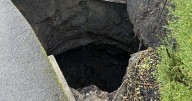 Couple who live next to giant sinkhole that appeared over weekend 'have suitcases packed'