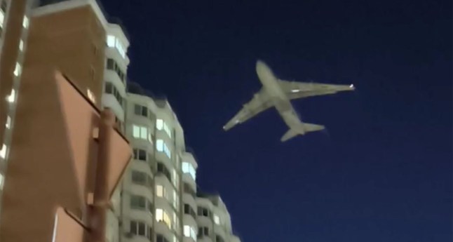 One of the world’s largest cargo planes comes within metres of a block of flats to avoid drones