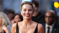 Margot Robbie shows off bra in sultry tailored suit