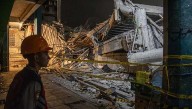 Rescuers run oxygen to survivors in Indonesia school building collapse that buried dozens