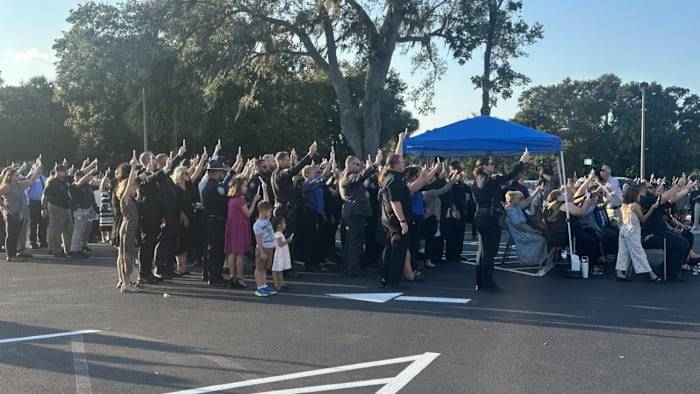 Community honors fallen Edgewater officer at candlelight vigil