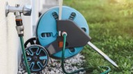The Genius Way To Repurpose A Garden Hose Reel For Better Garage Organization
